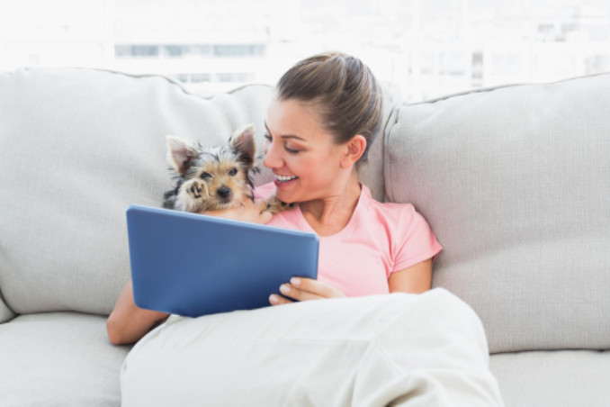 Dog on couch with owner: Richmond’s Indoor Air Quality Blog