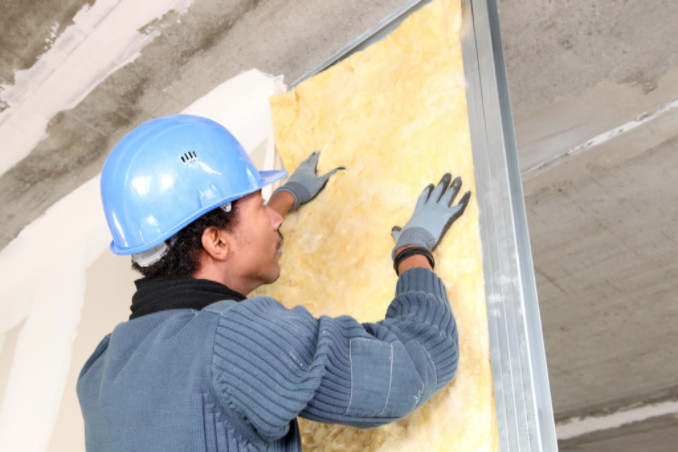 man fitting insulation: Richmond’s Air Indoor Comfort Systems blog