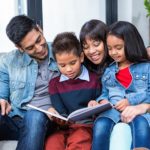 Family reading book on couch: Richmond’s Energy Savings Blog