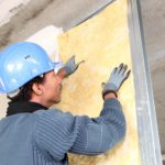 man fitting insulation: Richmond’s Air Indoor Comfort Systems blog